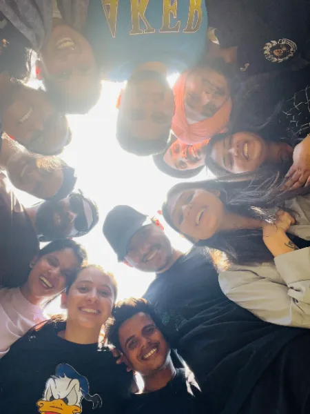 UIUX Studio team taking a group selfie outdoors