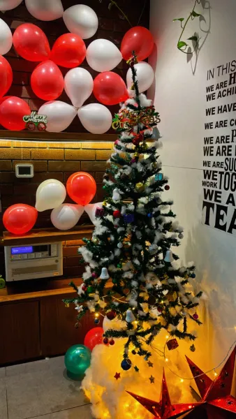 Office decorated with balloons and a Christmas tree