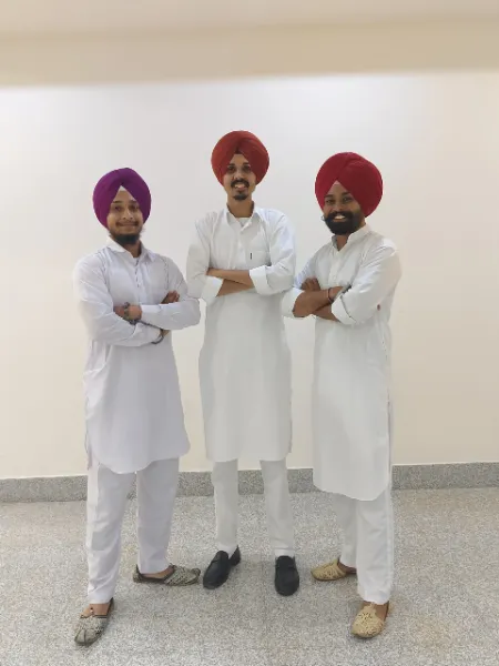 Three UIUX Studio team members in traditional white kurtas