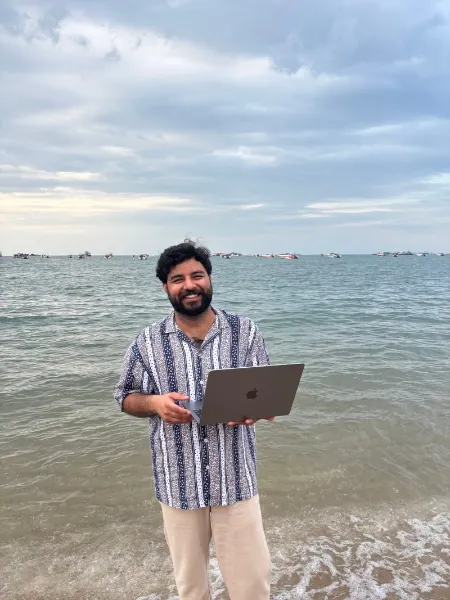 UIUX Studio team member working on a laptop by the sea