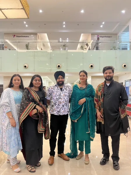 UIUX Studio team members in festive wear at an office celebration