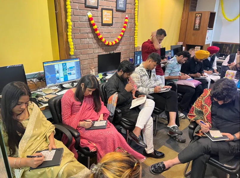 UIUX Studio team at their desks in an office decorated for a festival