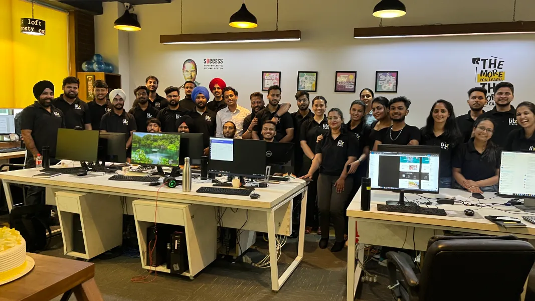 UIUX Studio team in matching T-shirts in the office