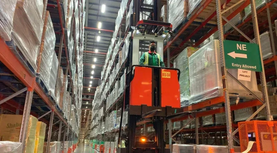 Warehouse forklift between racks